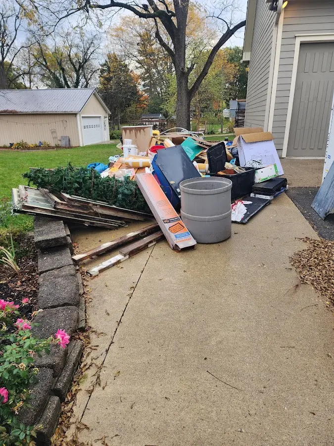Dumpster being loaded with debris for 3 Yard Dumpster Rental in Loch Lomond